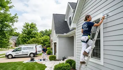 Professional house painters working on residential exterior in Saint Louis MO